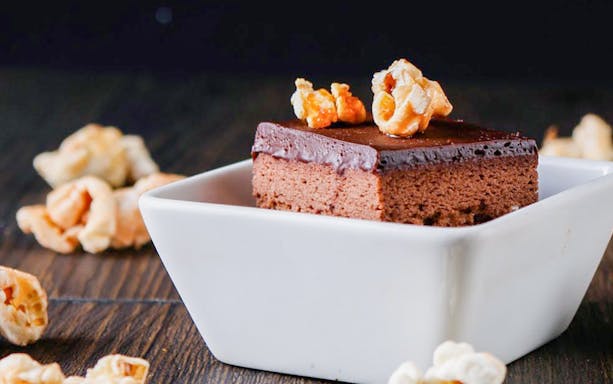 Chocolate cake with caramel popcorn in a white dish, Dining in the Dark, Kuala Lumpur.