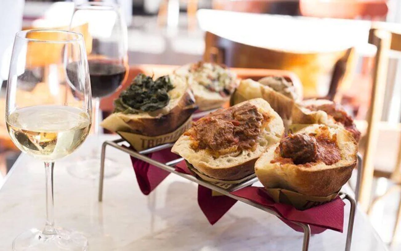 Traditional Italian bruschetta and wine on a table during Trastevere sunset food tour.