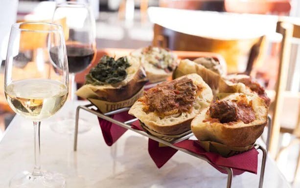 Traditional Italian bruschetta and wine on a table during Trastevere sunset food tour.