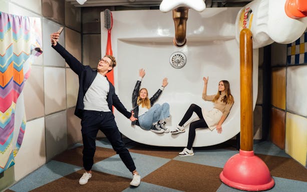 Visitors posing in the Upside Down House at the Big Fun Museum, Barcelona.