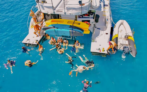 Tourists swimming near a chartered catamaran in the Whitsundays.