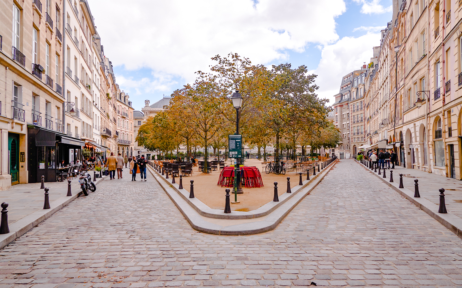 Place Dauphine in Paris with cobblestone streets and outdoor café seating.