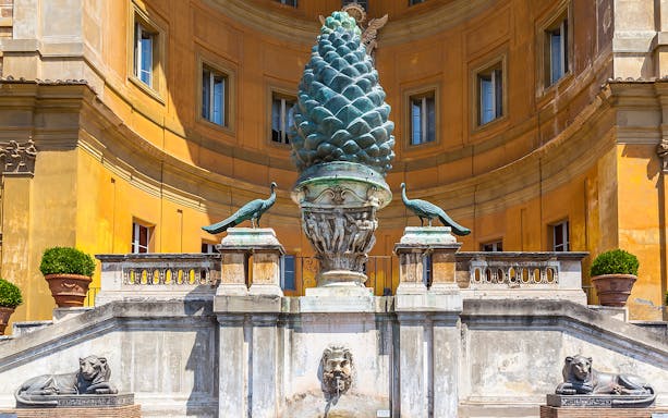Pinecone sculpture and peacocks in Vatican Museums courtyard, Rome.