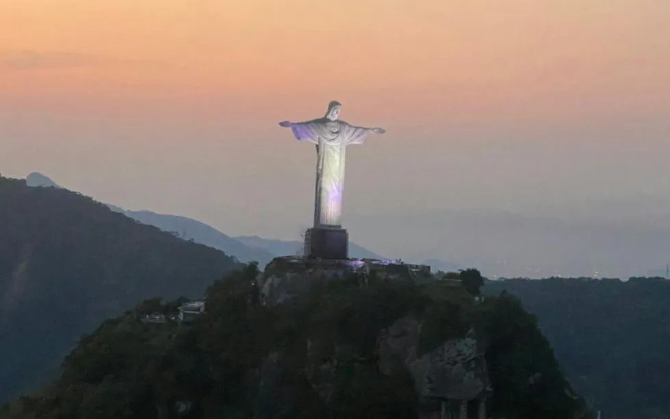 Christ the Redeemer statue at sunset during helicopter tour in Rio de Janeiro.