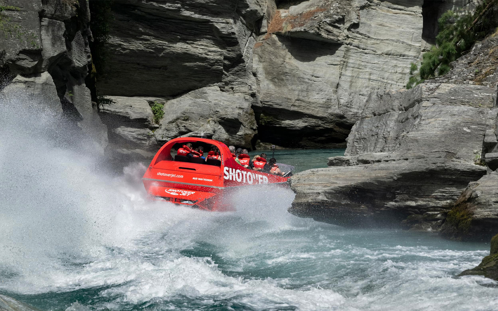 Shotover Jet navigating through narrow canyon waters.