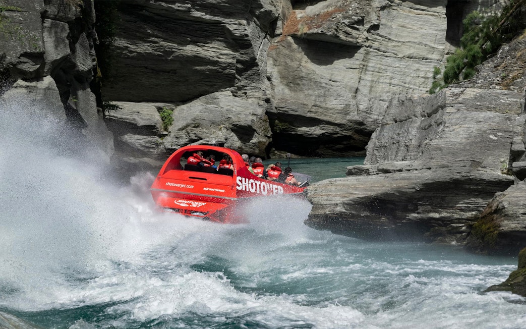 Shotover Jet navigating through narrow canyon waters.