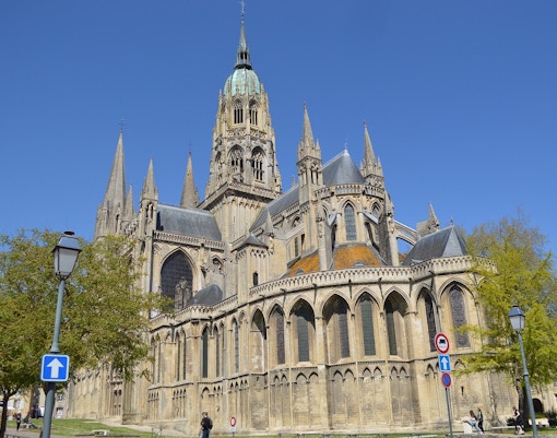 Bayeux Cathedral in Normandy with intricate Gothic architecture and towering spires.