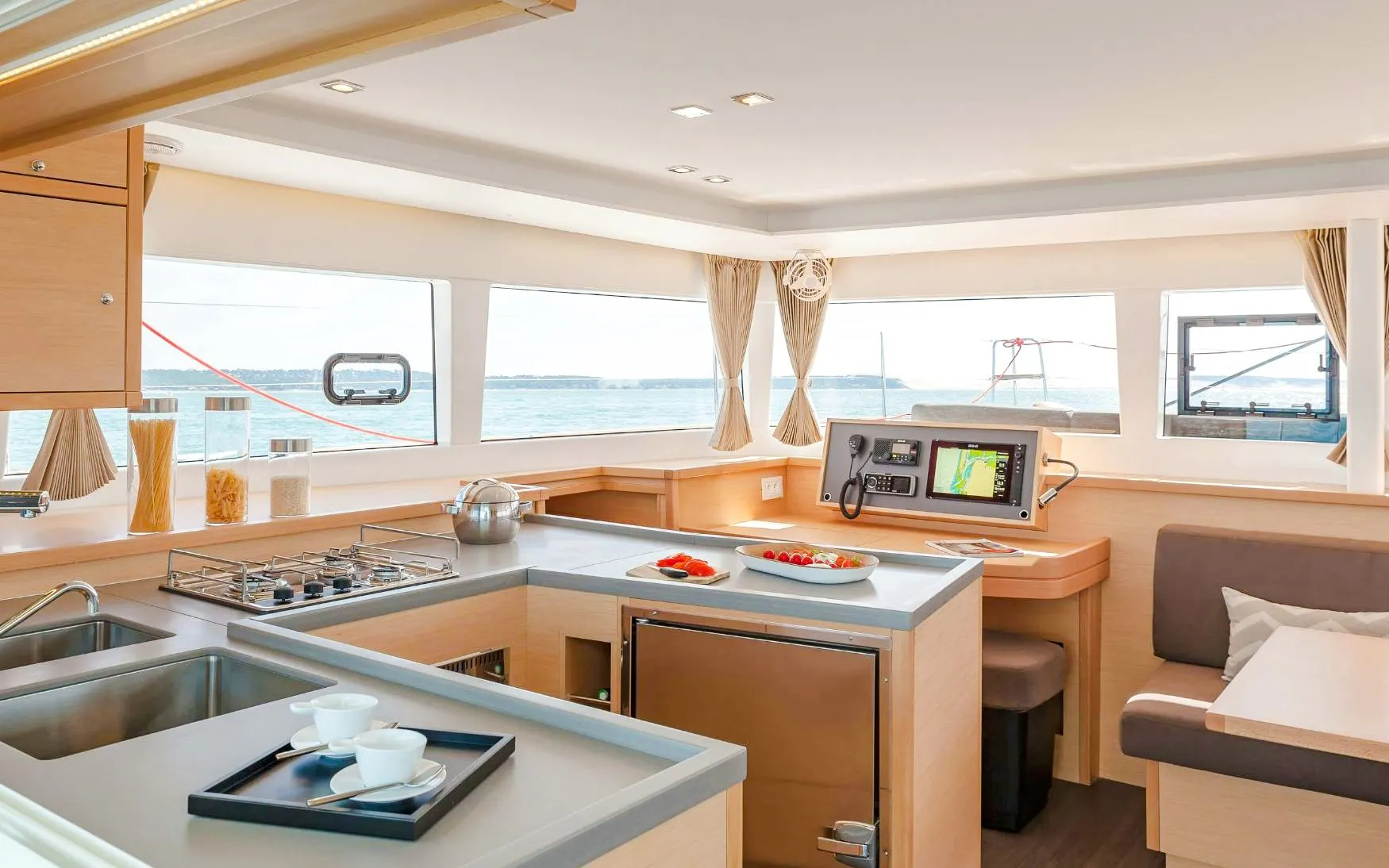 Catamaran interior with kitchen and seating area on Heraklion cruise.