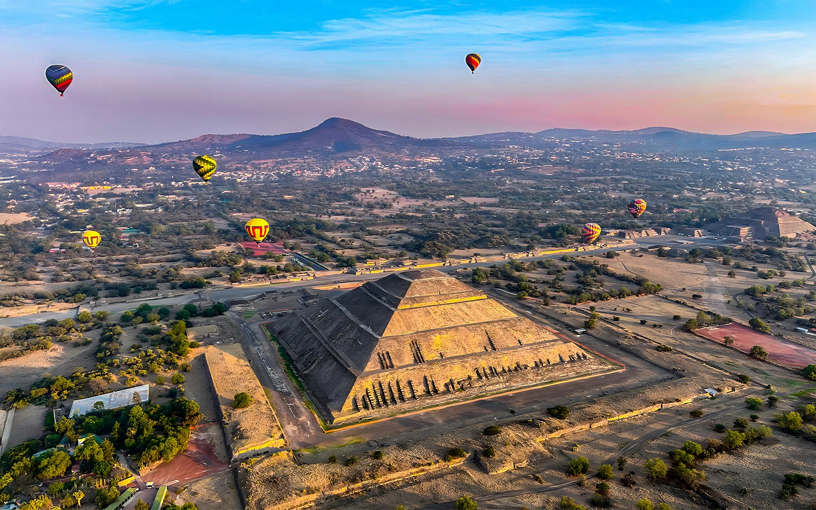 Hot air balloons over Pyramid of the Sun, Teotihuacan, Mexico.