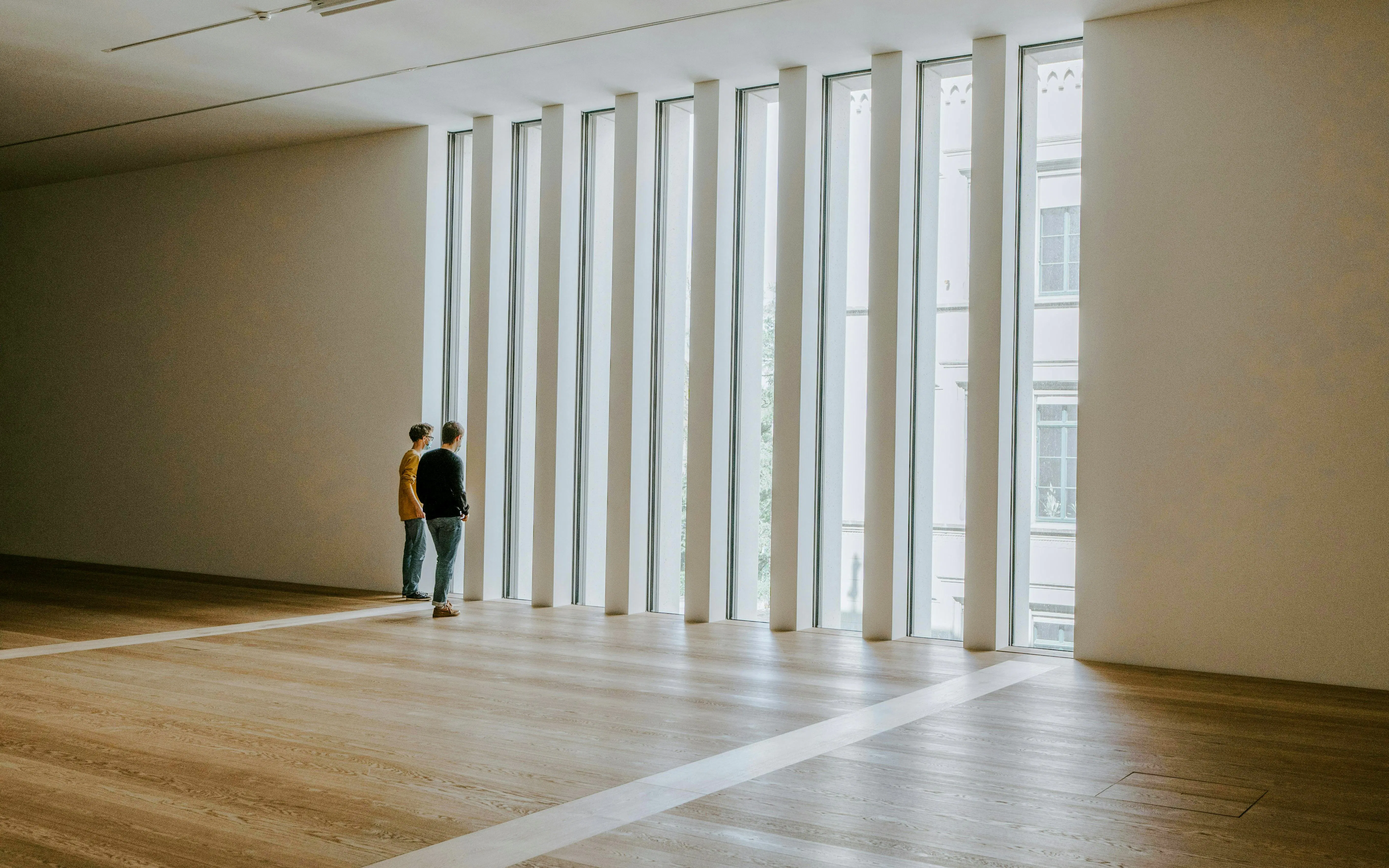 Visitors observing large windows inside Kunsthaus Zürich.
