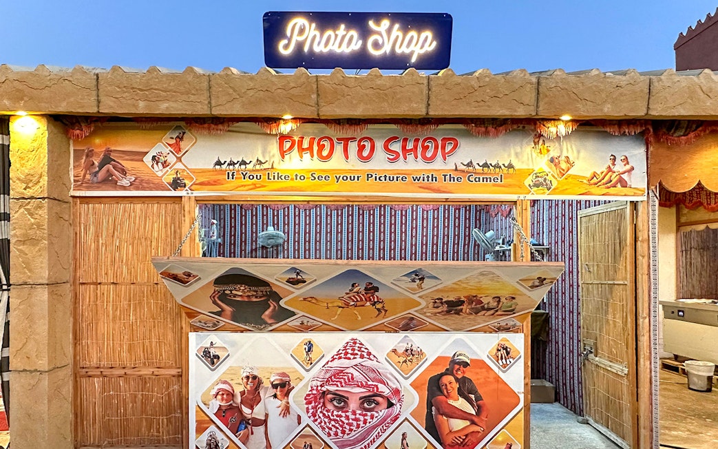 Photo shop booth for desert safari experience with camel ride images.