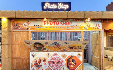 Photo shop booth for desert safari experience with camel ride images.