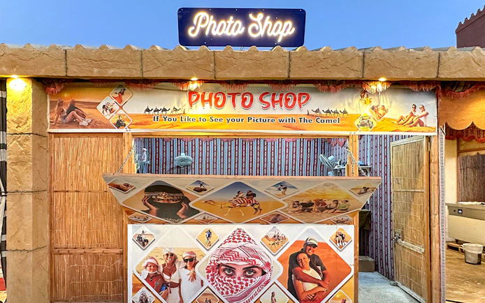 Photo shop booth for desert safari experience with camel ride images.