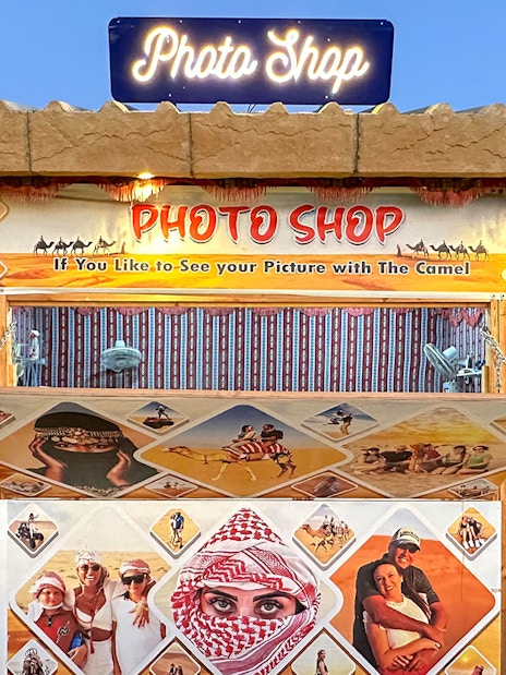 Photo shop booth for desert safari experience with camel ride images.