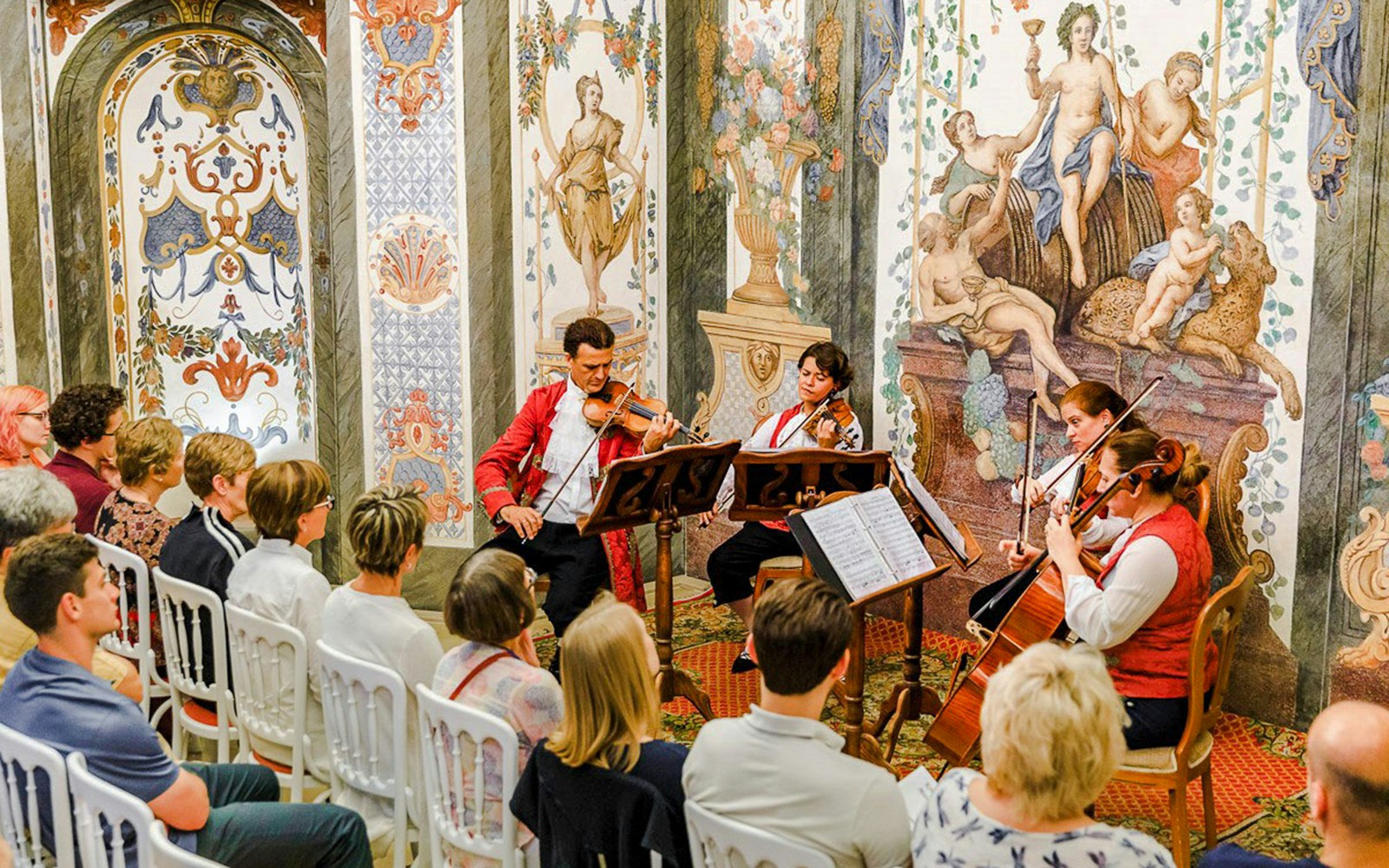Musicians performing at Mozarthaus Vienna Ensemble Concert with audience seated.