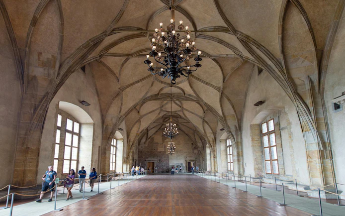 Vladislav Hall interior with vaulted ceilings and chandeliers in Prague Castle, Czech Republic.