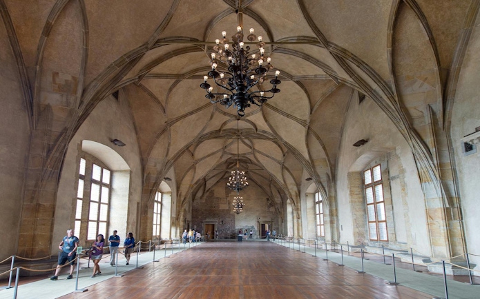 Vladislav Hall interior with vaulted ceilings and chandeliers in Prague Castle, Czech Republic.