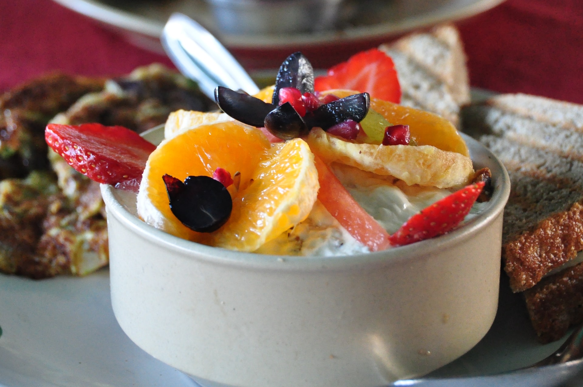 Dining tables set in a vibrant restaurant with patrons enjoying meals.