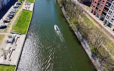 Guests navigating a self-drive electric boat on a canal in Gdansk.