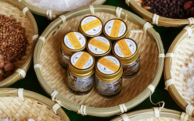 Jars of Thai handmade spices in bamboo baskets at Bangkok Elephant Park.