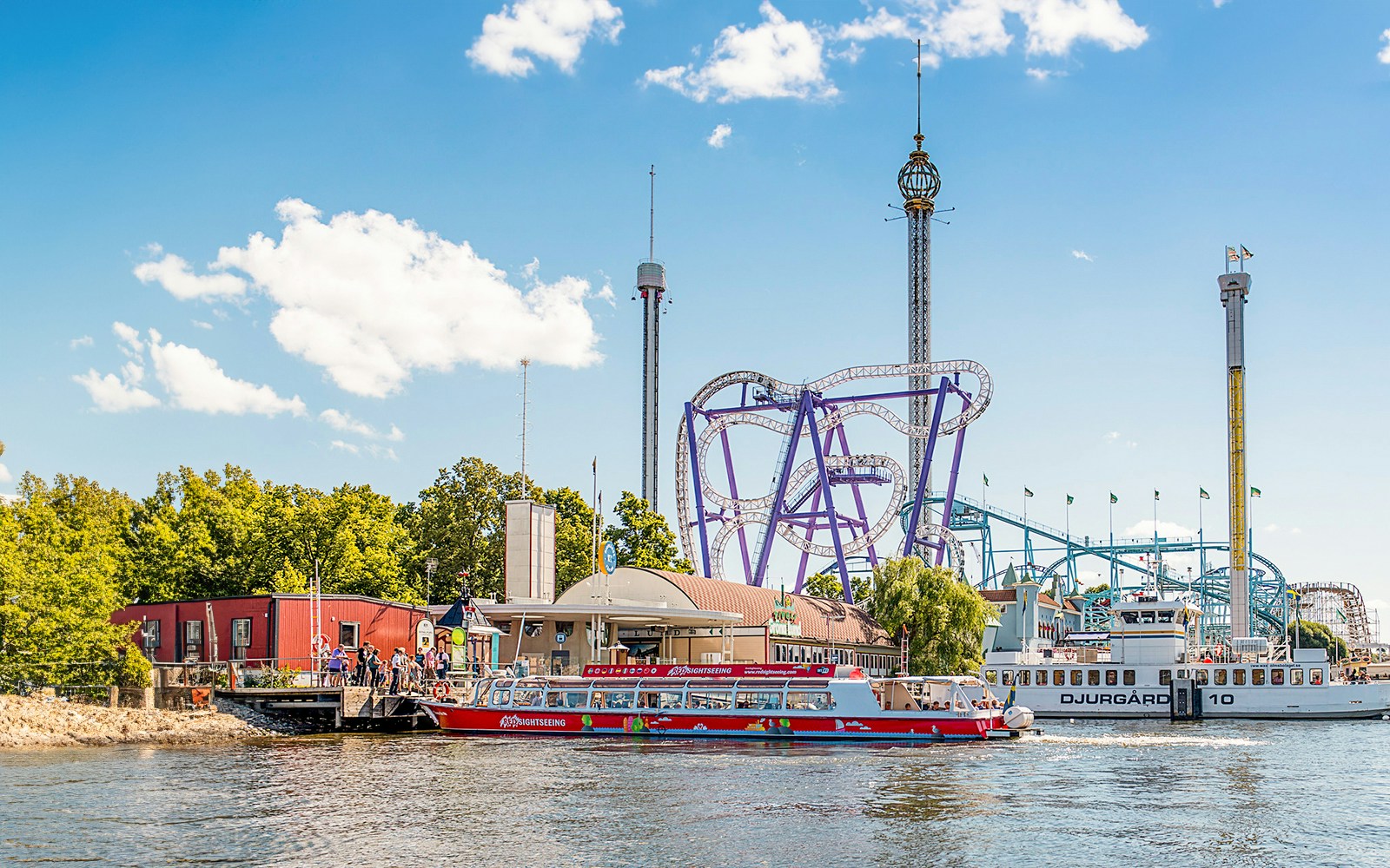 Tourists enjoying a Stockholm boat HOHO rollercoaster ride with a scenic view of the city's waterfront architecture