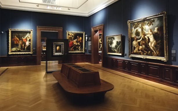 Museum of Fine Arts Budapest gallery with classic paintings displayed on blue walls.