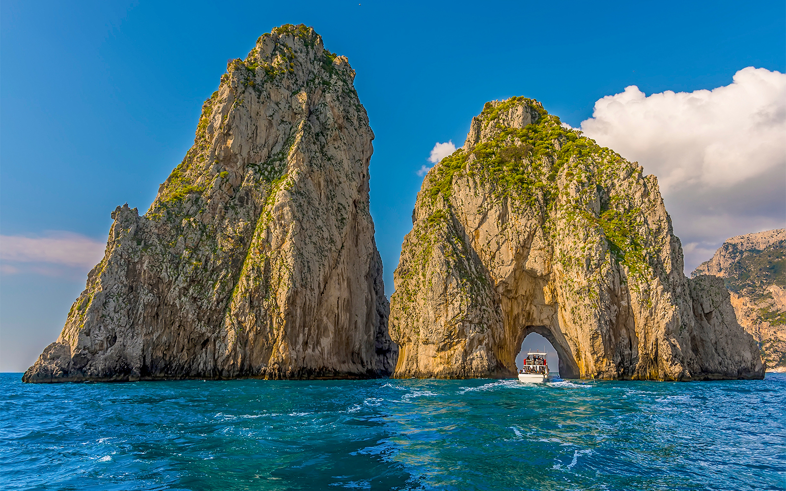 Faraglioni Rocks viewed from a boat on the Rome to Capri tour.