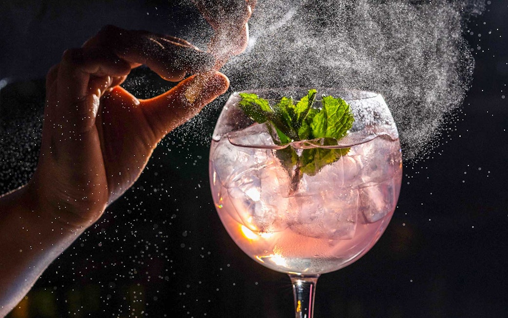 Cocktail preparation at CÉ LA VI Dubai with mint garnish and ice.