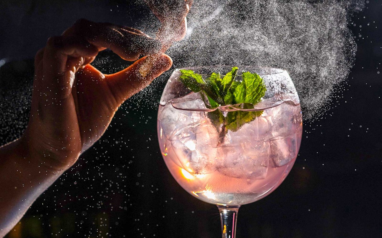 Cocktail preparation at CÉ LA VI Dubai with mint garnish and ice.