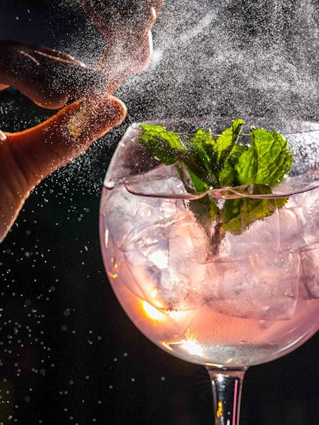 Cocktail preparation at CÉ LA VI Dubai with mint garnish and ice.