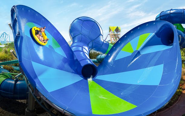 Raft on Ray Rush slide at Aquatica Orlando with riders enjoying the water attraction.