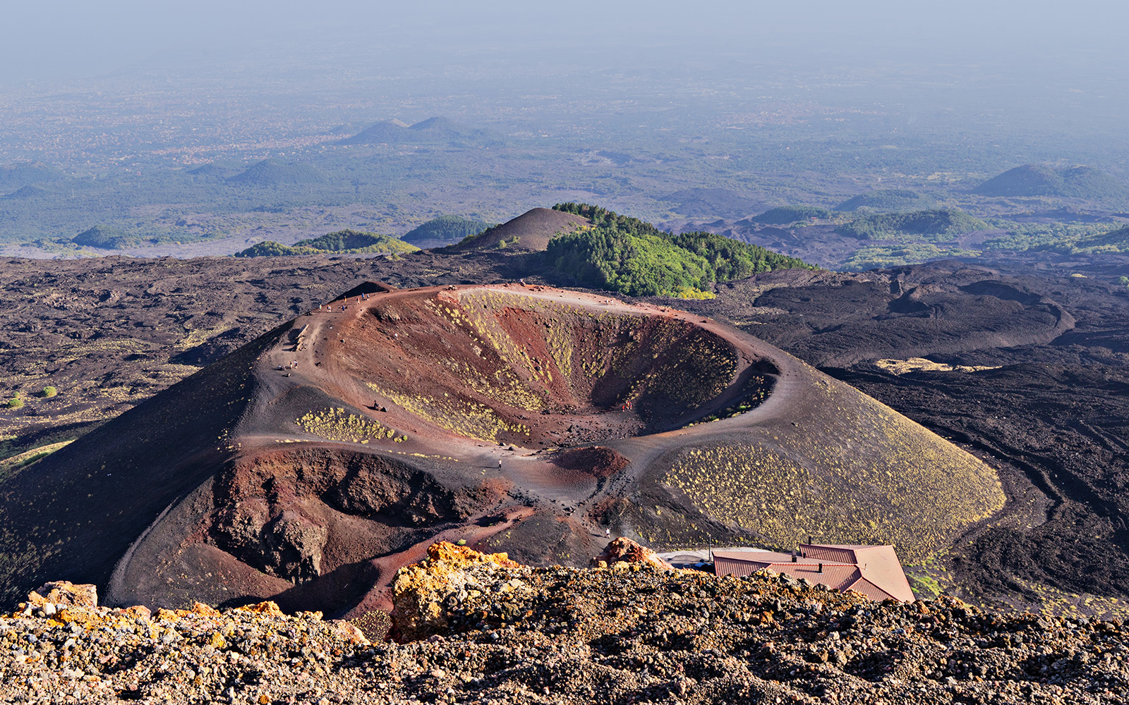 Mount Etna craters in Sicily, Italy, showcasing volcanic landscape and rugged terrain.