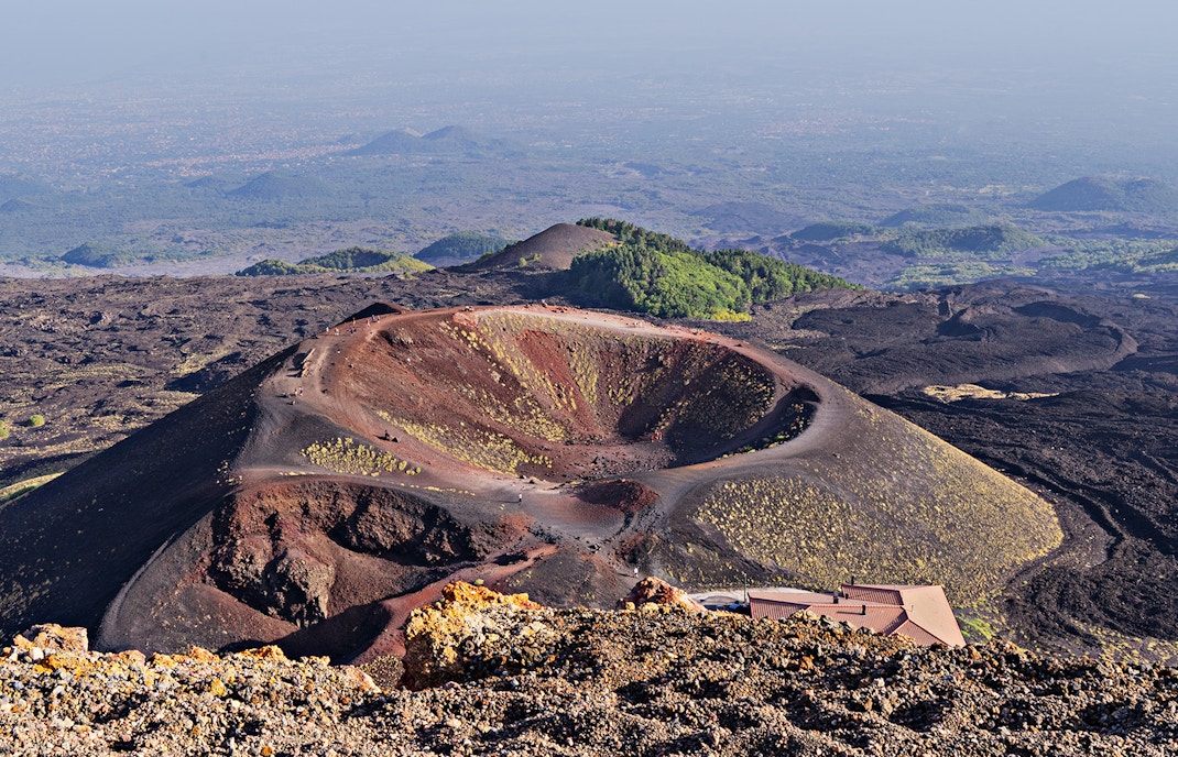 Mount Etna craters in Sicily, Italy, showcasing volcanic landscape and rugged terrain.