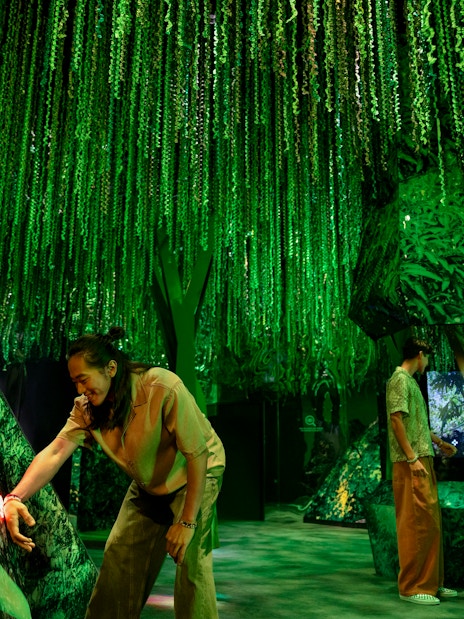 Visitors exploring the lush green rainforest exhibit at Exploria, Mandai Wildlife.