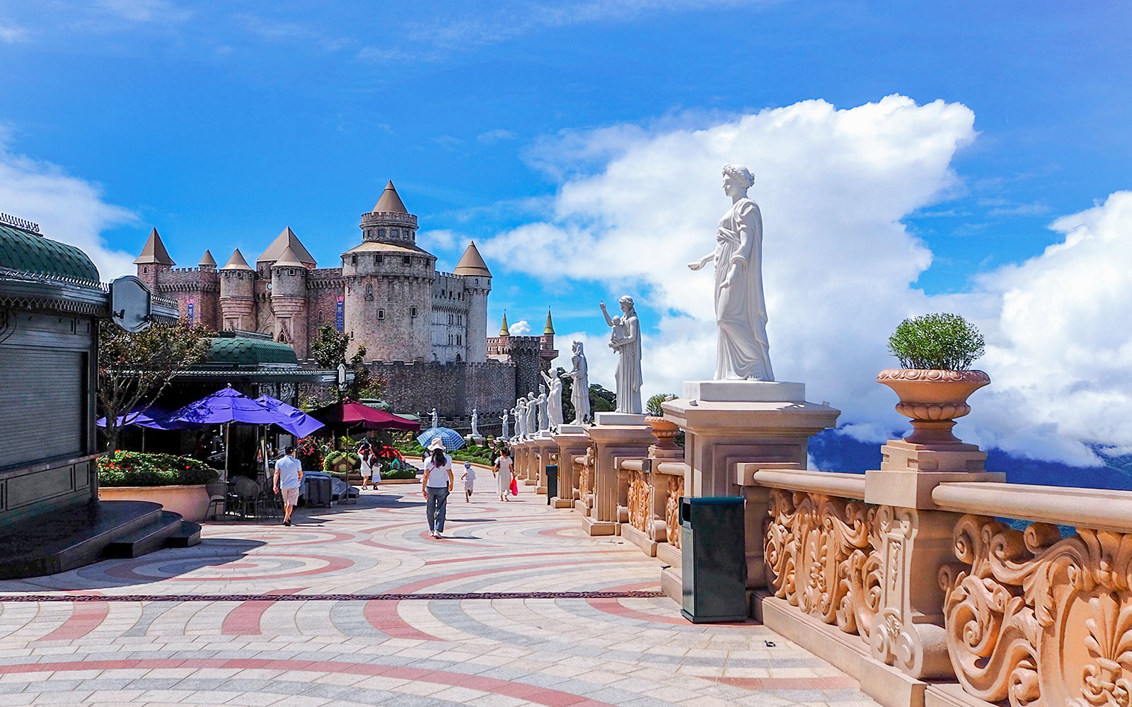 Luna Castle and statues in Ba Na Hills, Da Nang, Vietnam under a clear sky.