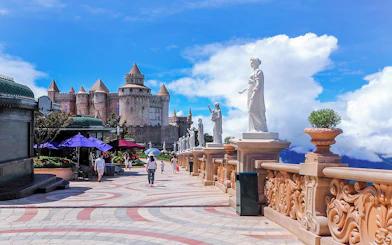 Luna Castle and statues in Ba Na Hills, Da Nang, Vietnam under a clear sky.