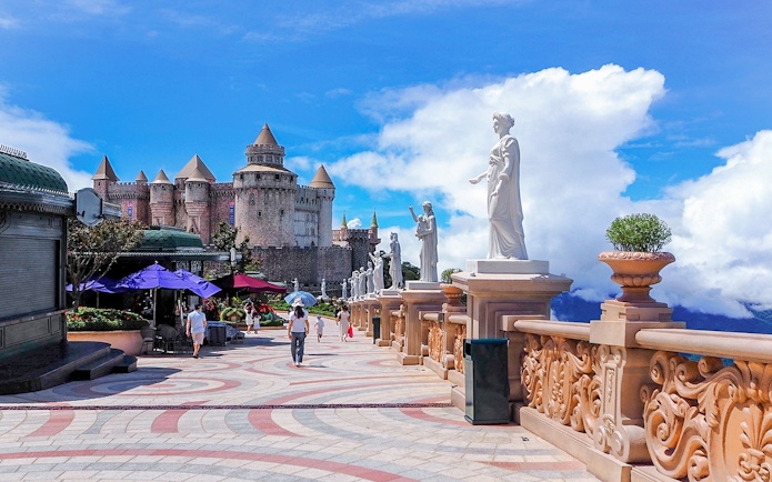 Luna Castle and statues in Ba Na Hills, Da Nang, Vietnam under a clear sky.
