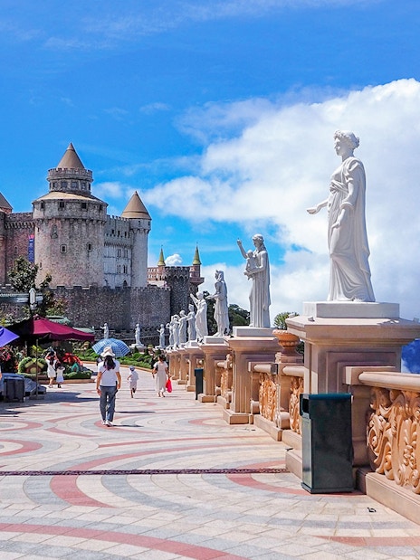 Luna Castle and statues in Ba Na Hills, Da Nang, Vietnam under a clear sky.