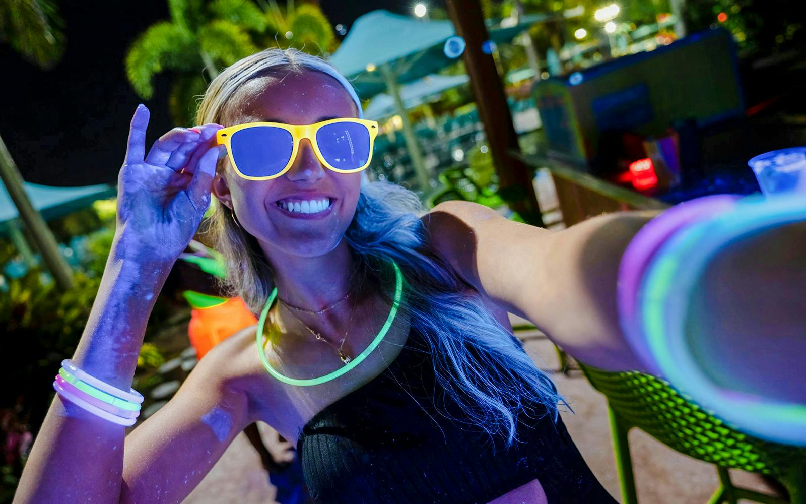 Guest enjoying neon lights at AquaGlow event, Water Country USA.