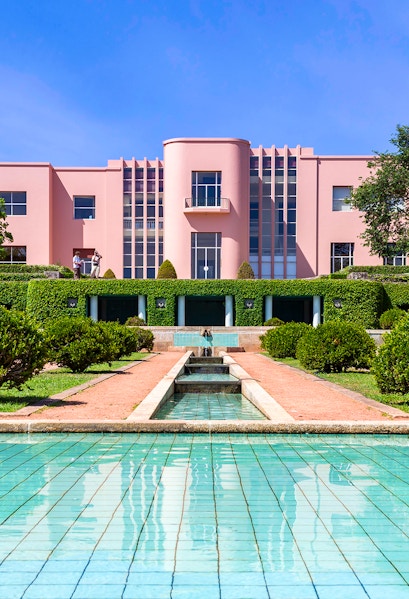 Modern pink art deco building with reflecting pool at Serralves Park, Porto.