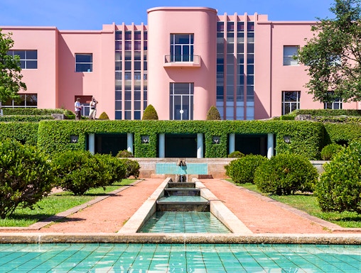 Modern pink art deco building with reflecting pool at Serralves Park, Porto.