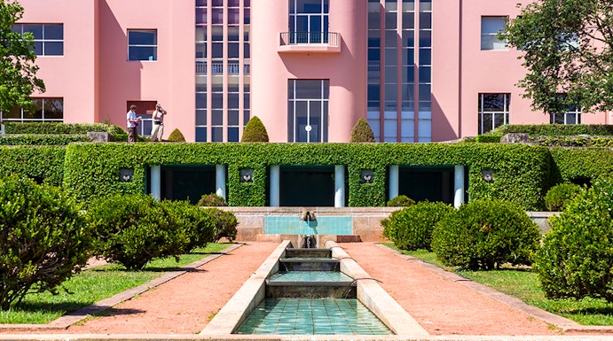 Modern pink art deco building with reflecting pool at Serralves Park, Porto.