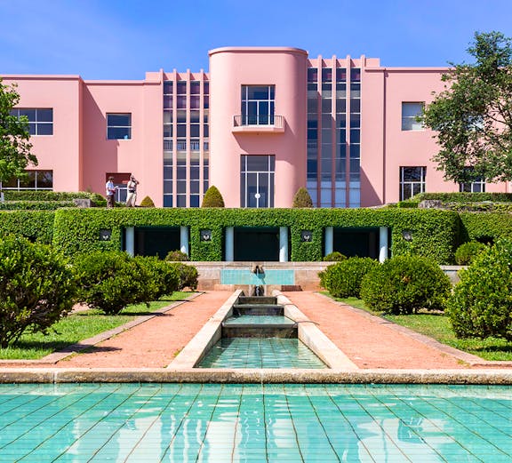 Modern pink art deco building with reflecting pool at Serralves Park, Porto.