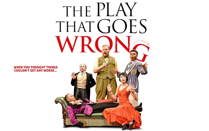 Cast of "The Play That Goes Wrong" in comedic poses on stage.