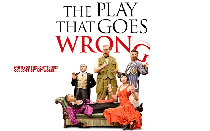 Cast of "The Play That Goes Wrong" in comedic poses on stage.