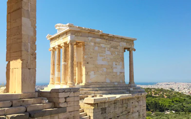 Temple of Athena Nike on the Acropolis, Athens, with cityscape in the background.