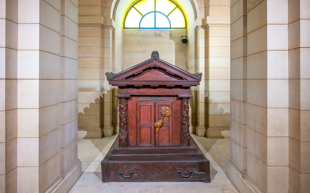 Tomb of Rousseau in the Paris Pantheon, featuring ornate carvings and classical architecture.