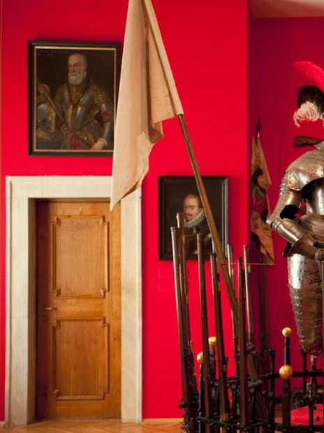 Knight armor display at Lobkowicz Palace Museum with historical weapons in Prague.