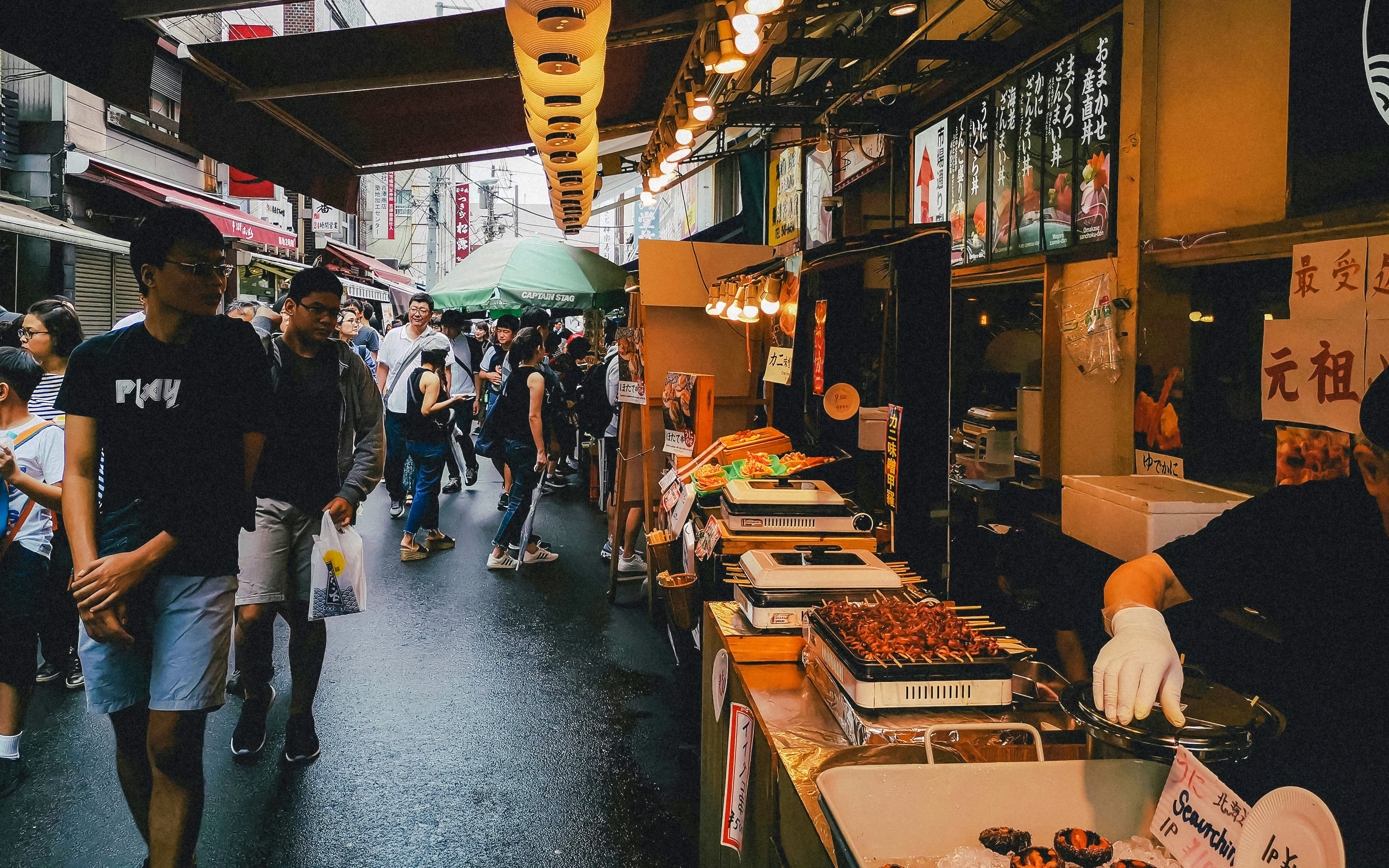 Street food market bustling with people during Tokyo Night Tour.