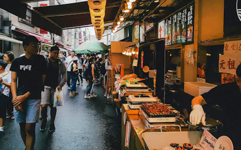 Street food market bustling with people during Tokyo Night Tour.